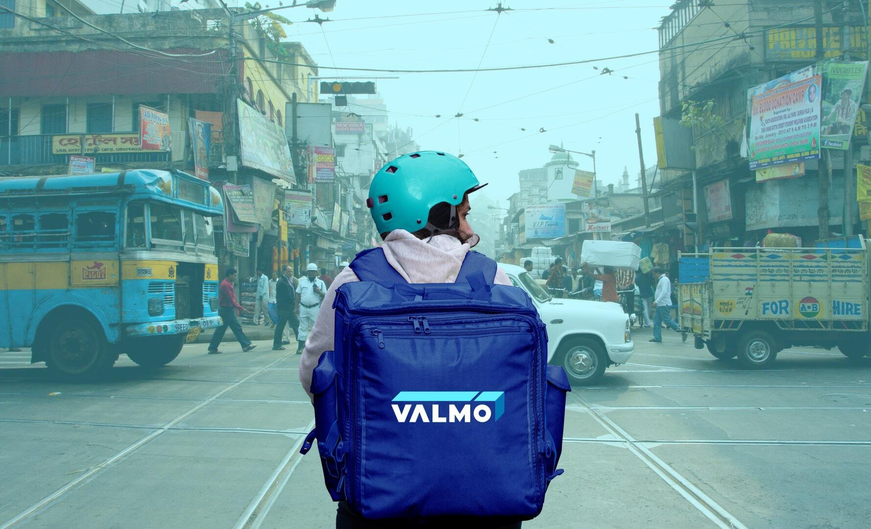A Valmo delivery boy moving across street of India.